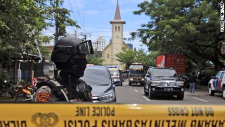 A police officer stands guard near the church in Makassar, South Sulawesi, Indonesia after Sunday&#39;s explosion.