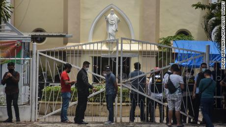 Indonesian police examine the site outside a church after an explosion in Makassar on March 28.