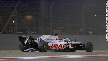 Haas F1&#39;s Russian driver Nikita Mazepin sits in his damaged car after crashing out during the Bahrain Grand Prix.