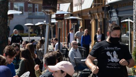 People dine outside at a restaurant in Plymouth, Michigan, on Sunday, March 21, 2021