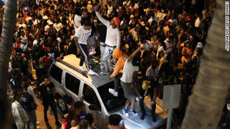 People gathered as an 8 p.m. curfew went into effect on March 21 in Miami Beach, Florida. College students flooded the area for spring break, prompting officials to impose a curfew due to the pandemic.