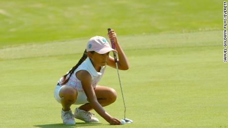 Avery lines up a putt. 