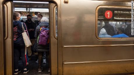 People wearing masks on a subway car on March 29, 2021 in New York City