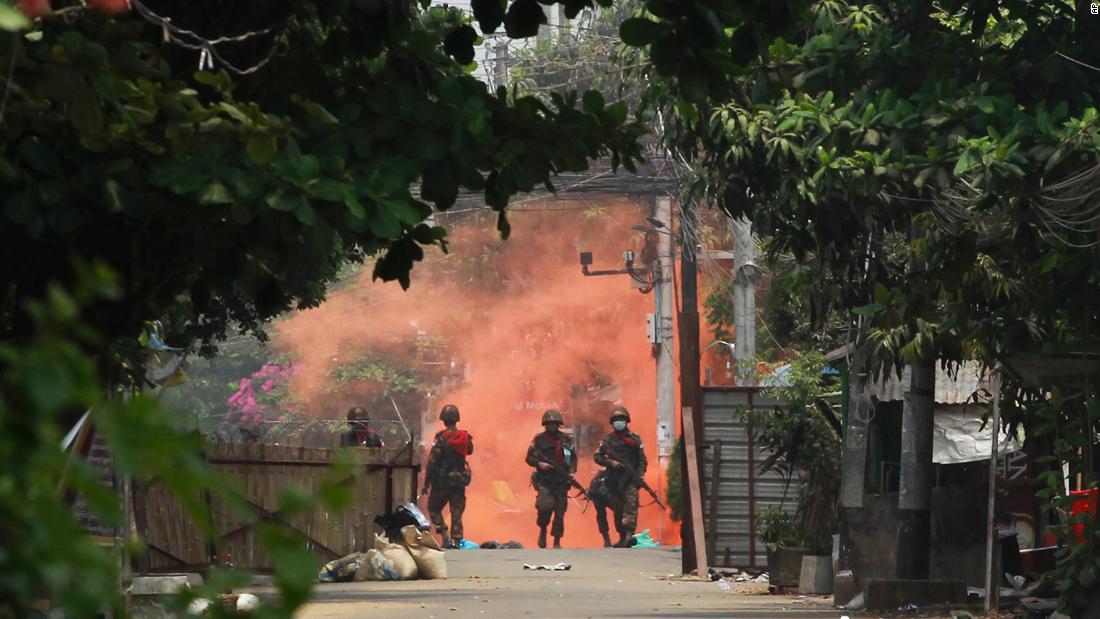 Soldiers walk toward anti-coup protesters during a demonstration in Yangon on March 30.