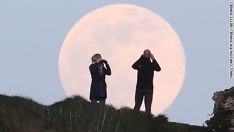 A pink supermoon rises over the Rock of Dunamase in County Laois in the Republic of Ireland. Despite its name, there is no actual colour change to the appearance of the lunar surface - it is a Northern Native American reference to an early-blooming wildflower, which starts to pop up in the US and Canada at the beginning of spring. (Photo by Niall Carson/PA Images via Getty Images)