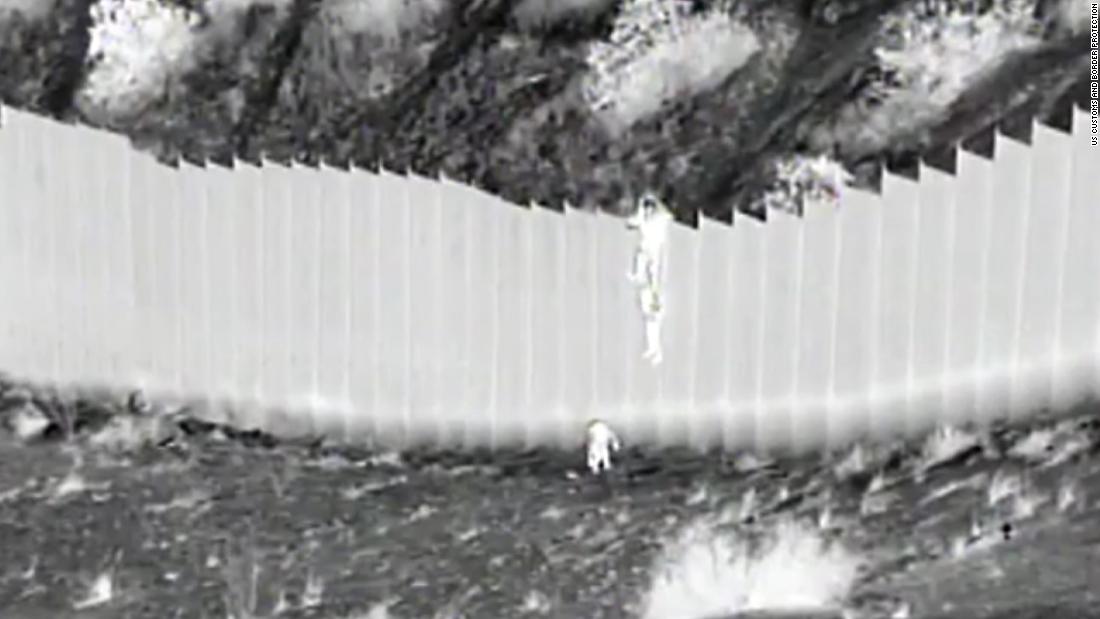 Border patrol video shows young children being dropped over 14-foot border fence into the US