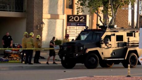 A police truck is parked outside the scene of a mass shooting in Orange, California.