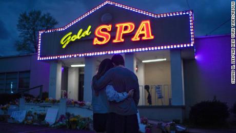 Cynthia Shi and boyfriend Graham Bloomsmith kiss outside the Gold Massage Spa in Atlanta on Thursday, March 18.