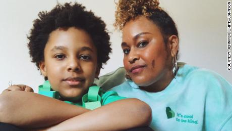 Jennifer White-Johnson sits with her 8-year-old Black and autistic son, Kevin &#39;Knox&#39; Johnson III.