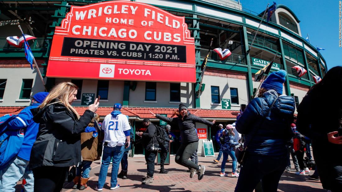 An excited fan poses for a photo outside Wrigley Field in Chicago.