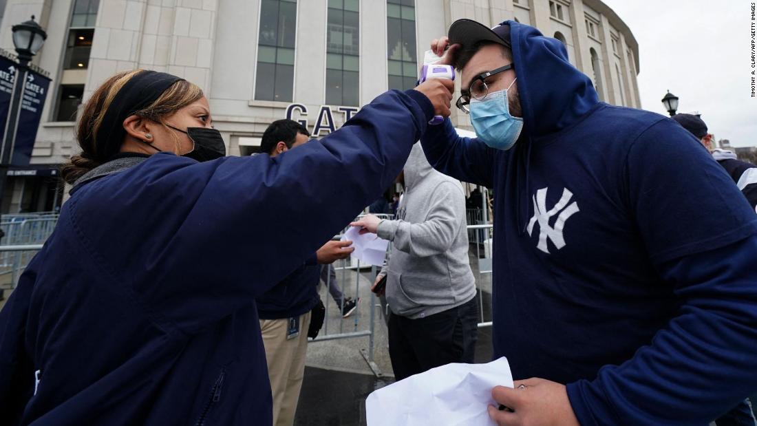 A Yankees fan has his temperature checked before entering the stadium on Thursday.