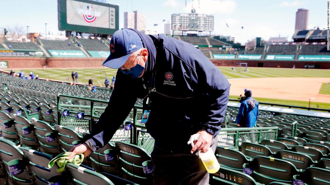 An usher cleans the seats before the Chicago Cubs hosted Pittsburgh at Wrigley Field.