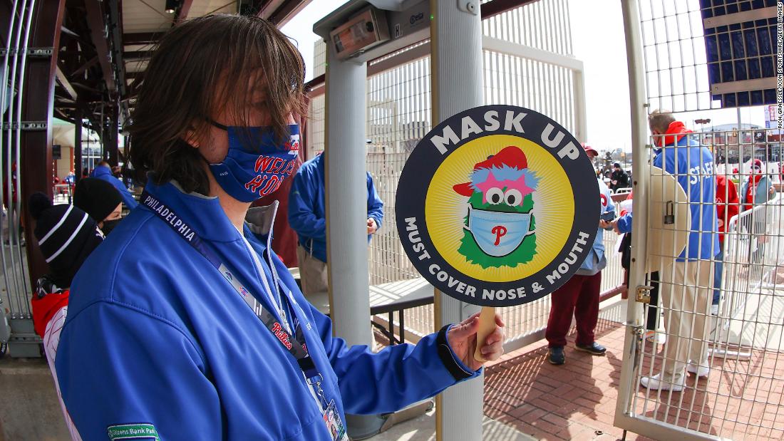 The Phillie Phanatic, the iconic mascot of the Philadelphia Phillies, is seen on a sign urging fans to &quot;mask up&quot; at Citizens Bank Park.