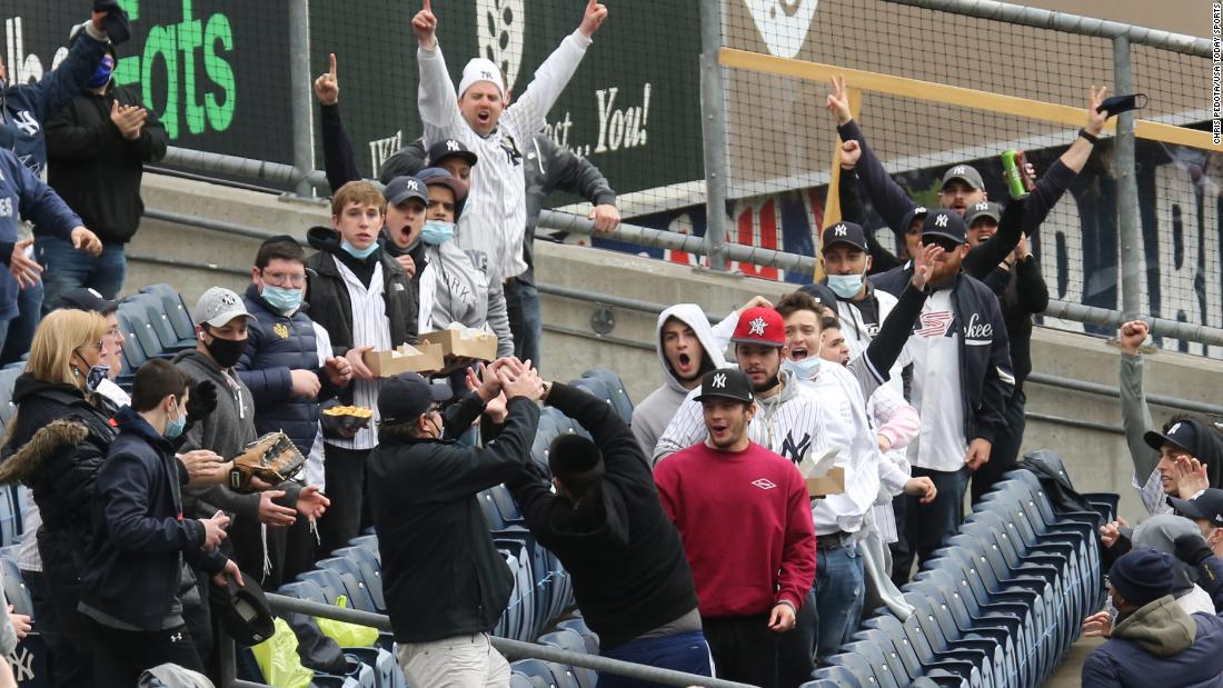 Fans catch a home run hit by Yankees slugger Gary Sanchez.