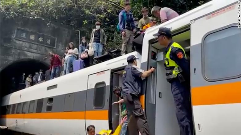 Passengers are helped to climb out of the train in Hualien County, Taiwan, on April 2.