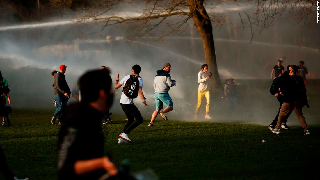 People scatter as police fire water cannons to disperse a crowd at a park in Brussels, Belgium, on April 1. &lt;a href=&quot;https://www.cnn.com/world/live-news/coronavirus-pandemic-vaccine-updates-04-02-21/h_bc4daabf47fa48f57503c7de2e9b9aff&quot; target=&quot;_blank&quot;&gt;Violent clashes broke out&lt;/a&gt; between Brussels police and people gathering to attend a fake April Fool&#39;s Day festival that violated coronavirus restrictions.