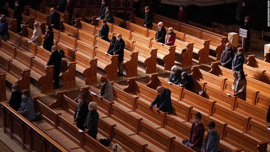 People wear face masks and observe social distancing as they attend a Good Friday church service in Berlin on April 2.