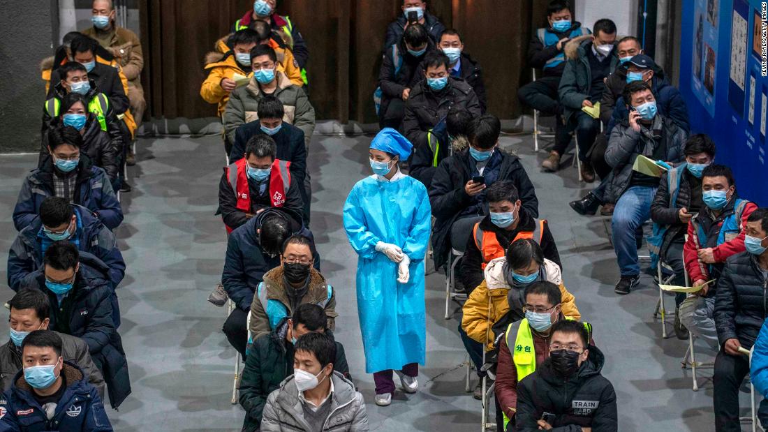 Chinese workers wait to receive a Covid-19 vaccine at a mass vaccination center in Beijing on January 15.