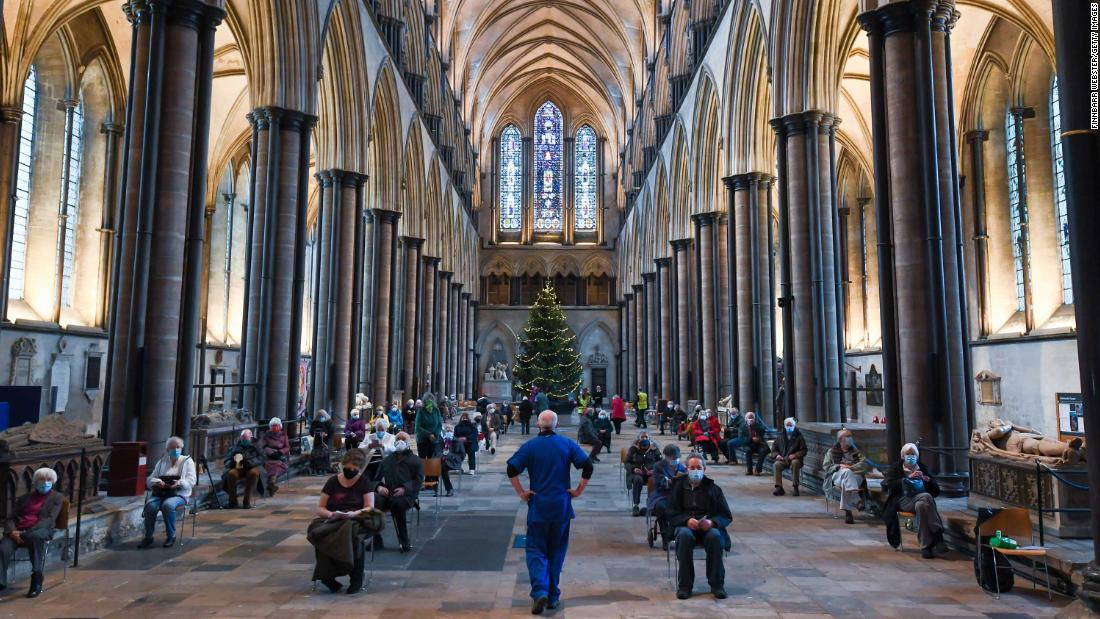 People wait to receive a Covid-19 vaccine January 20 at a vaccination center set up inside Salisbury Cathedral in Salisbury, England.