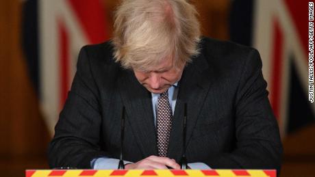 The UK Prime Minister looks down at the podium as he attends a virtual press conference on the pandemic, inside 10 Downing Street in January.