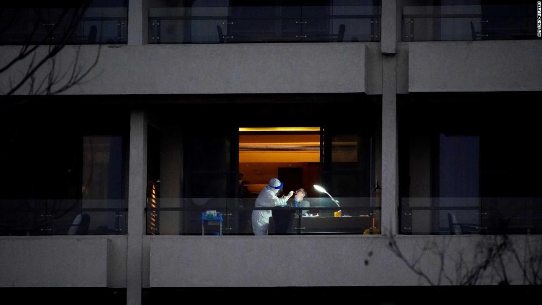 Peter Ben Embarek, a member of the World Health Organization team tasked with investigating the origins of Covid-19, receives a swab test on the balcony of a hotel in Wuhan, China, on February 3.