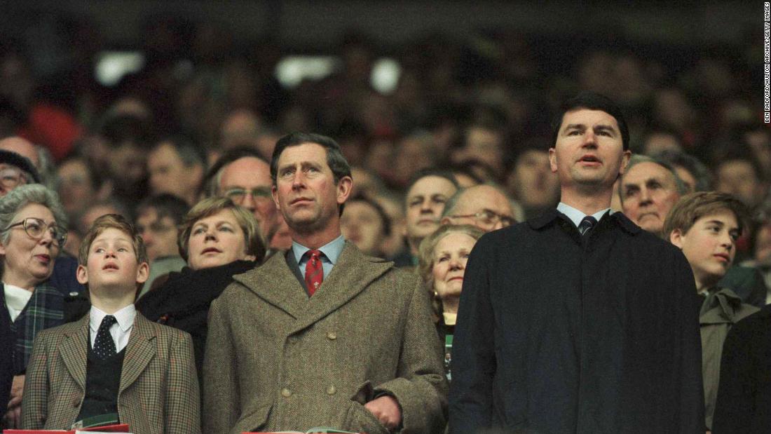 Prince Charles and Prince Harry, at left, stand for anthems as Prince William, right, looks around during the Five Nations rugby championship in 1996.