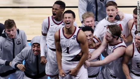 Jalen Suggs #1 of the Gonzaga Bulldogs celebrates with teammates after making a game-winning three in overtime to defeat the UCLA Bruins 93-90 during the 2021 NCAA Final Four semifinal at Lucas Oil Stadium on April 3, 2021.