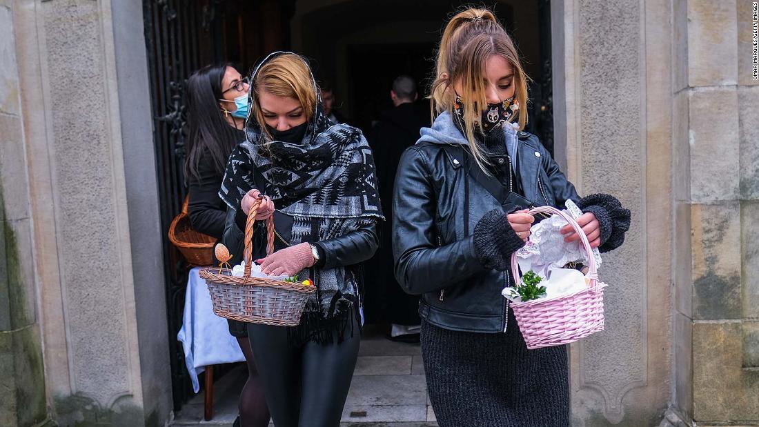 Women in Krakow, Poland, carry Easter baskets after a food-blessing ceremony at the Basilica of St. Michael the Archangel on April 3.