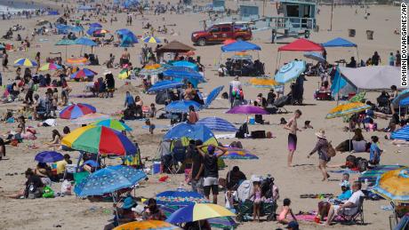 People enjoy the hot weather on Santa Monica Beach in Santa Monica, Calif., Wednesday, March 31, 2021. Half of the state&#39;s nearly 40 million people are now in the state&#39;s second-least restrictive orange tier amid low coronavirus case rates and increased vaccinations. Health officials in California and across the country are urging caution because of a troubling rise in new cases of COVID-19.  (AP Photo/Damian Dovarganes)