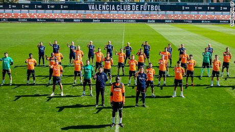Valencia&#39;s squad stands in solidarity at training on Monday.