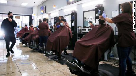 Barbers from King&#39;s Cutz give haircuts indoors while observing COVID-19 safety restrictions on March 13, 2021 in Los Angeles, California. 