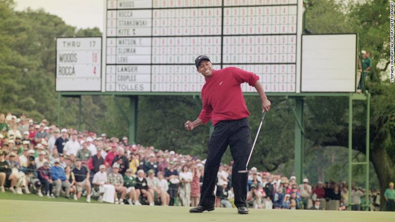 Woods celebrates after sinking a four-foot putt to win the 1997 Masters.