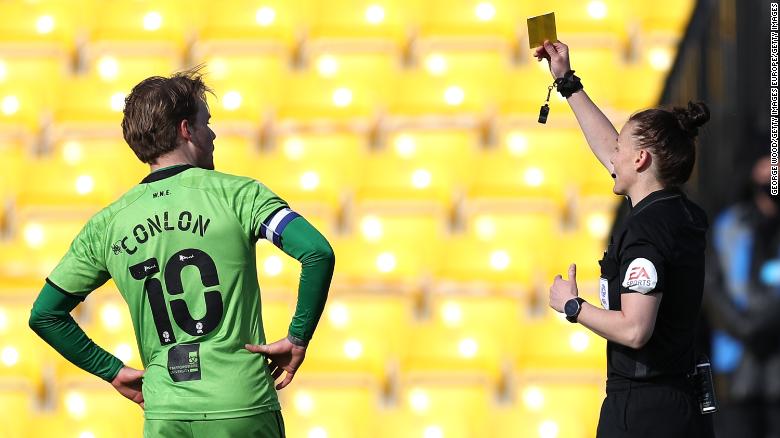 Rebecca Welch shows a yellow card to Tom Conlon of Port Vale in Monday's match.