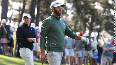 Defending champion Dustin Johnson (right) and Rory McIlroy walk the fourth fairway after teeing off during their practice round for the Masters.