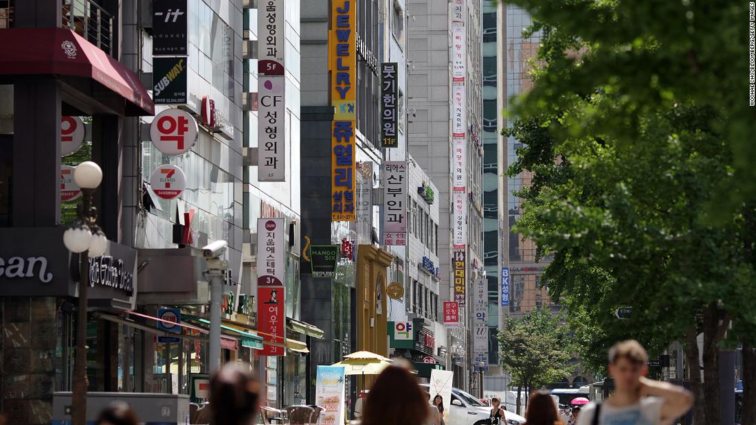 Signs for plastic surgery clinics are displayed on the side of a building in the Sinsa-dong area of Gangnam district in Seoul, South Korea, on August 3, 2013.