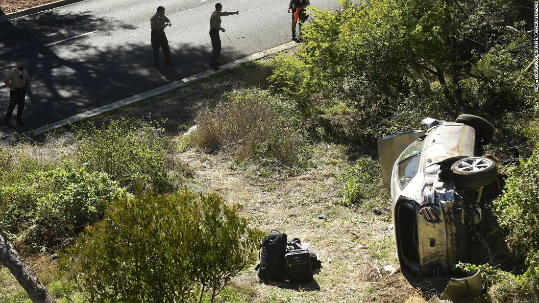 Law enforcement officers investigate the scene of Woods&#39; rollover crash in Rancho Palos Verdes, California, in February 2021. Woods &lt;a href=&quot;https://www.cnn.com/2021/04/07/us/tiger-woods-update-crash-cause/index.html&quot; target=&quot;_blank&quot;&gt;suffered serious leg injuries&lt;/a&gt; in the one-car accident and had to be pulled from his vehicle by emergency responders. 