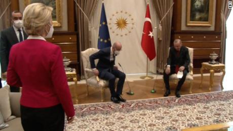 European Commission President Ursula von der Leyen (left) is seen standing as European Council President Charles Michel (center) and Turkish President Recep Tayyip Erdogan (right) take their seats.
