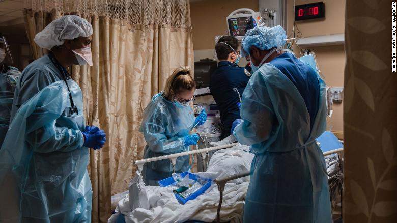 Healthcare workers tend to a patient with Covid-19 who is having difficulty breathing in a Covid holding pod at Providence St. Mary Medical Center in Apple Valley, California on January 11, 2021. 