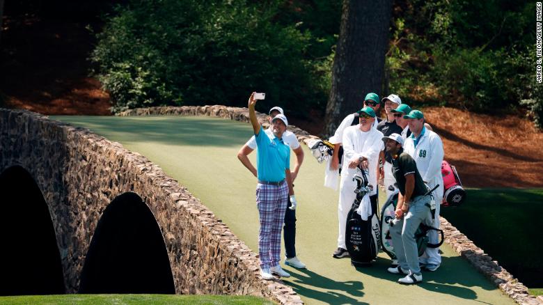 During a practice round on Wednesday, April 7, Ian Poulter takes a Hogan Bridge selfie with his playing partners and their caddies.