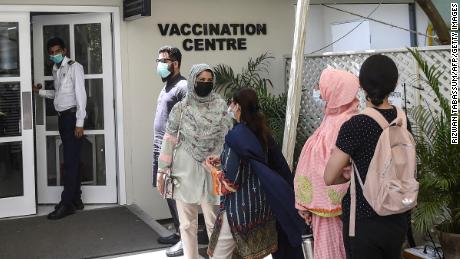 People wait to receive a dose of Russia&#39;s Sputnik V vaccine in Karachi, Pakistan, on April 5.