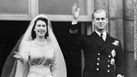 Princess Elizabeth and Prince Philip wave to the crowd from a balcony of Buckingham Palace shortly after their wedding at London&#39;s Westminster Abbey in 1947.