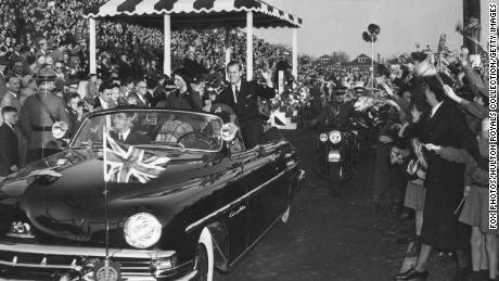 Princess Elizabeth and the Duke of Edinburgh greet a crowd during their tour of Hamilton, Canada in 1951.