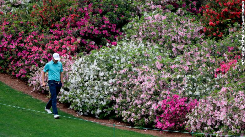 Former Masters champion Jordan Spieth walks past the azaleas on the sixth fairway on April 9. He finished with a 4-under 68 to move just a couple of shots away from the lead.
