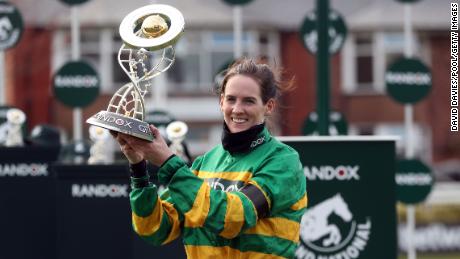 Rachael Blackmore receives the Randox Grand National Handicap Chase trophy after winning on Minella Times.