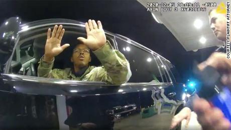 Caron Nazario is seen in this still image of a body cam holding his hands up in the air before a police officer sprays him with pepper.