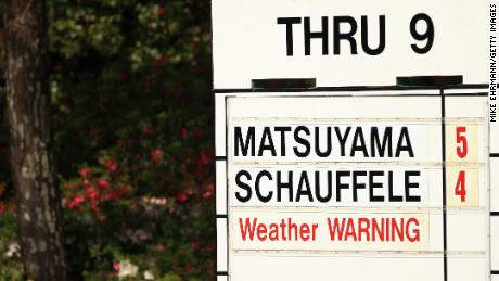 A detail of &#39;weather warning&#39; signage on a leaderboard during the third round of the Masters.