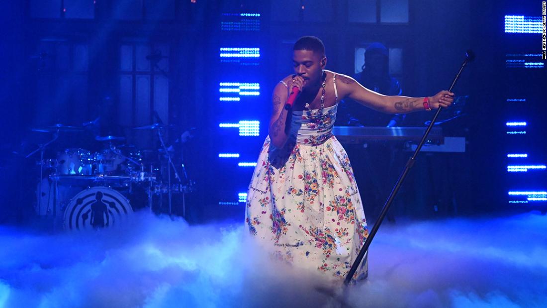 Kid Cudi wears a floral dress during the SNL show, while honoring Kurt Cobain and Chris Farley