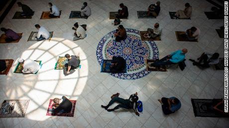 Men space out their prayer rugs during prayers at King Fahad Mosque in Culver City, California.