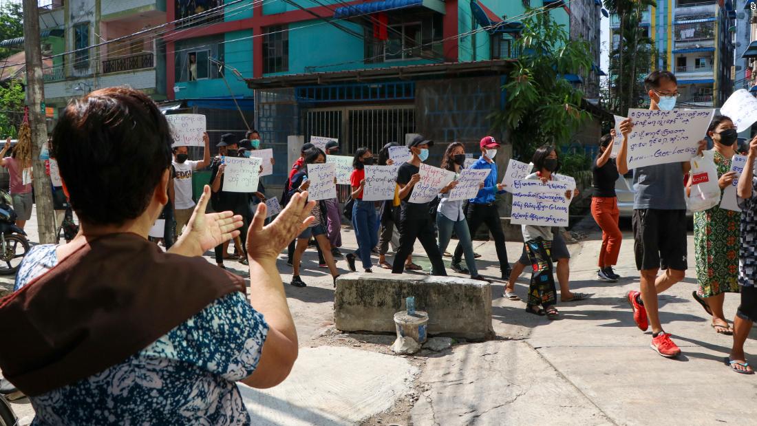 Anti-coup protesters walk through Yangon&#39;s Hlaing township on April 9.