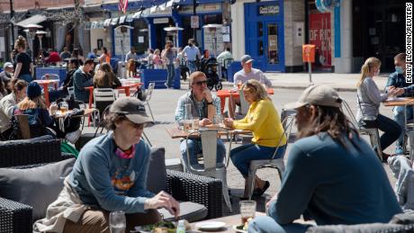 People dine outdoors at a restaurant in Ann Arbor, Michigan, on April 4.